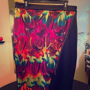 Black pencil skirt with colorful flare on front.